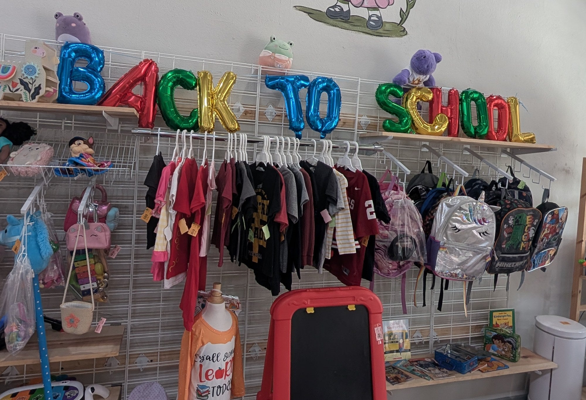 Back to School display with kids’ clothing and backpacks at Leapin’ Littles in Denison, TX
