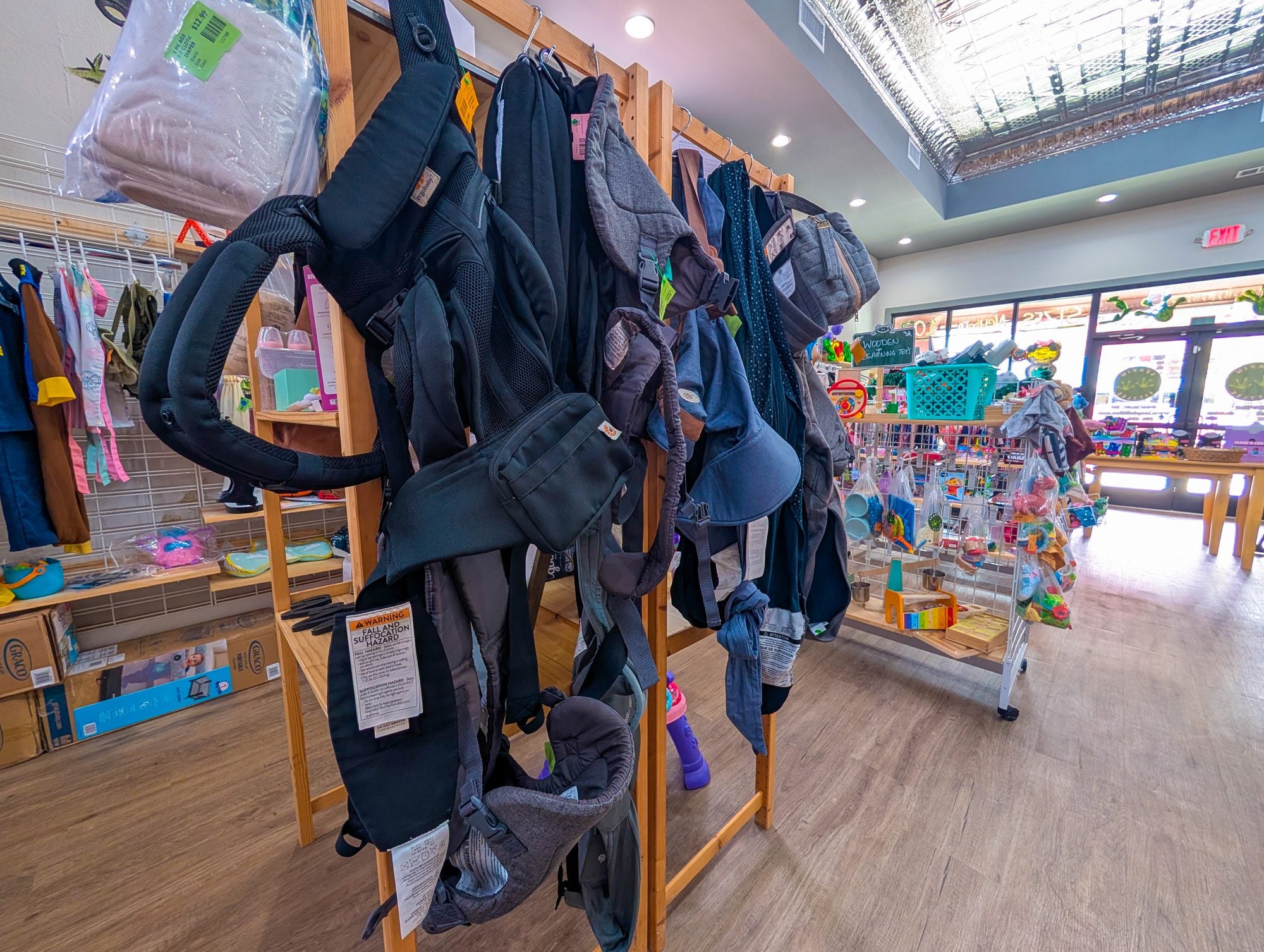 Baby carriers and gear on the shelves at Leapin' Littles, Denison TX
