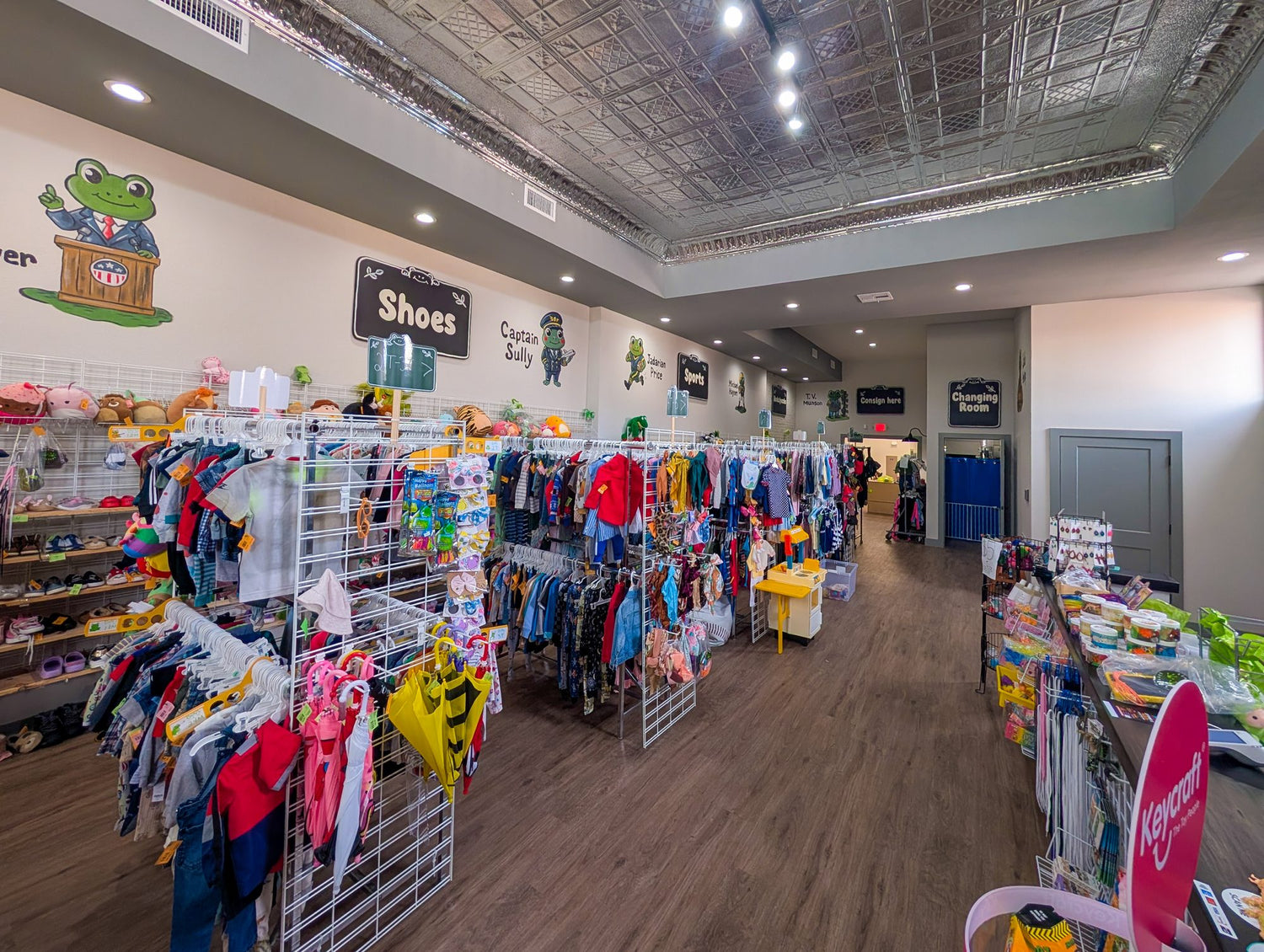 Inside Leapin' Littles — shoe wall and clothing racks