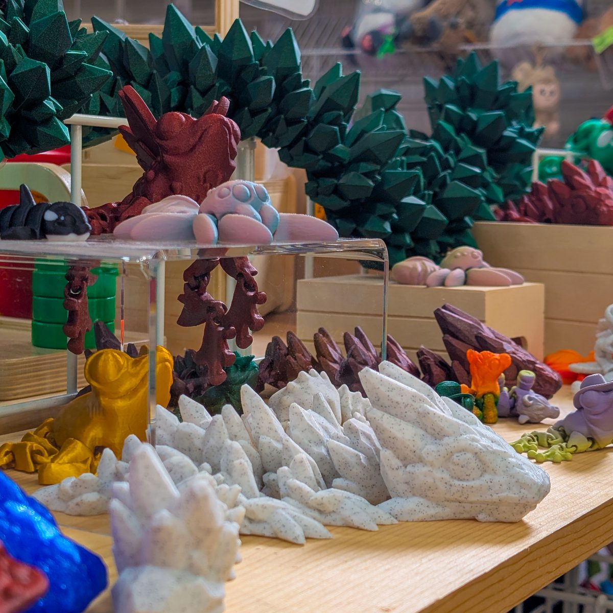 3D-printed dragons and crystals on the toy table at Leapin' Littles