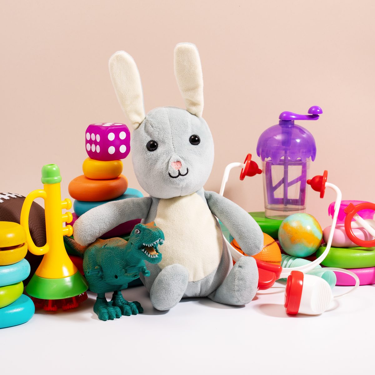 Secondhand children's toys — plush bunny, stacking rings, dinosaur and more
